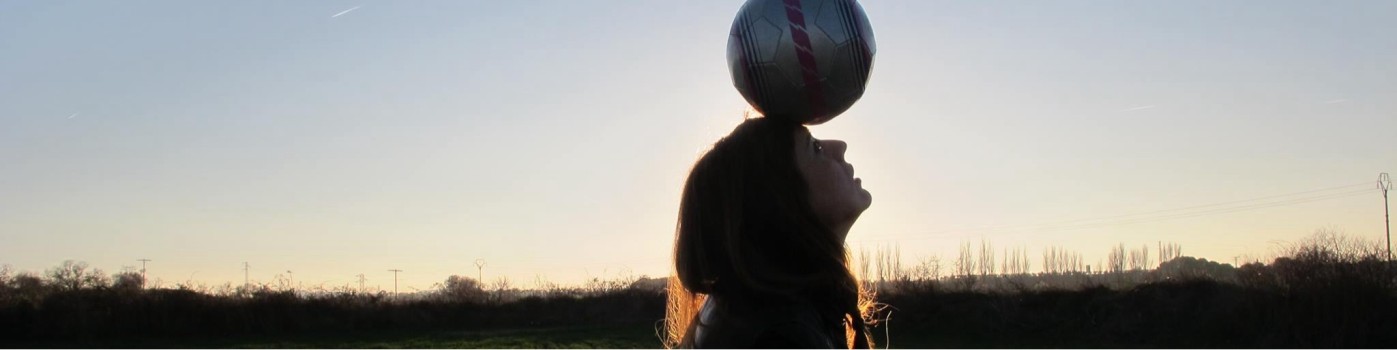 Football at sunset: balancing the ball and the horizon.